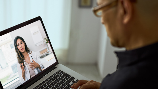 A man having a video visit with his doctor.