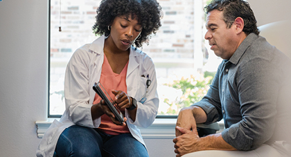 An AHN provider discussing treatment with a patient.